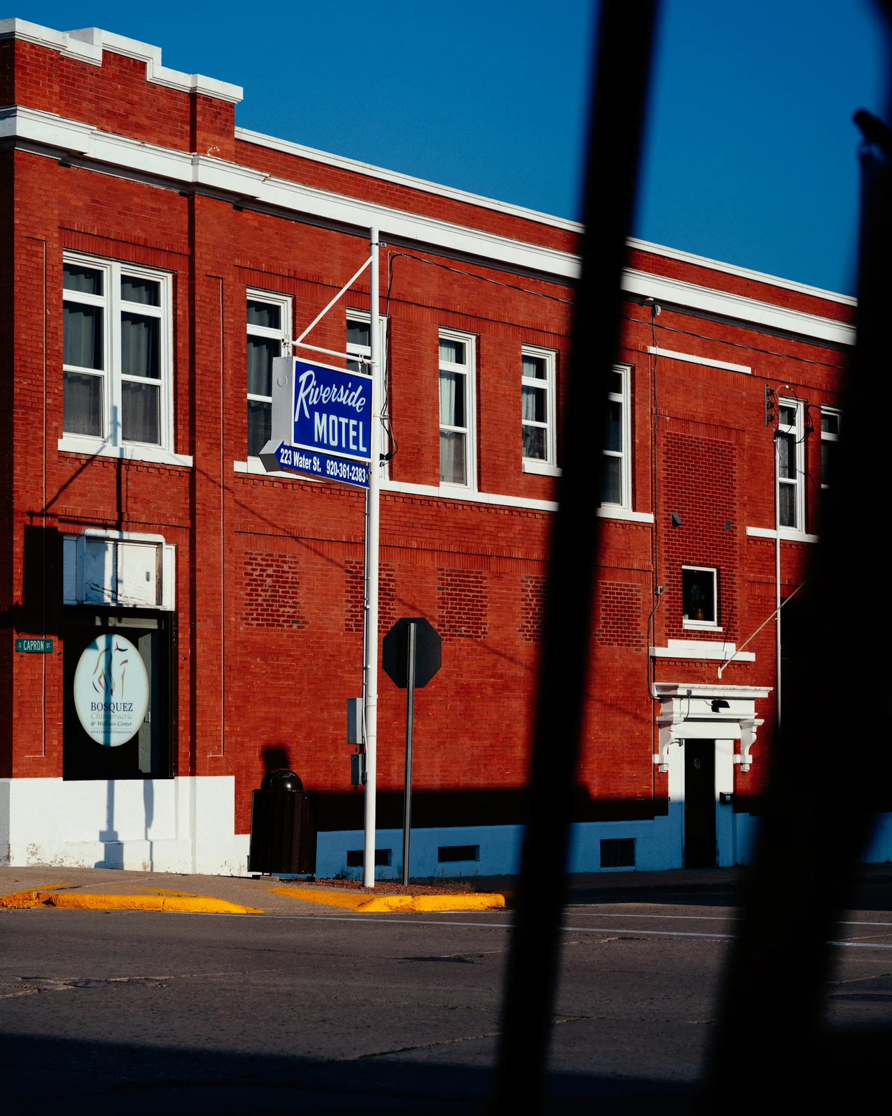 The Riverside Motel sign on a red-brick building in Berlin, Wisconsin