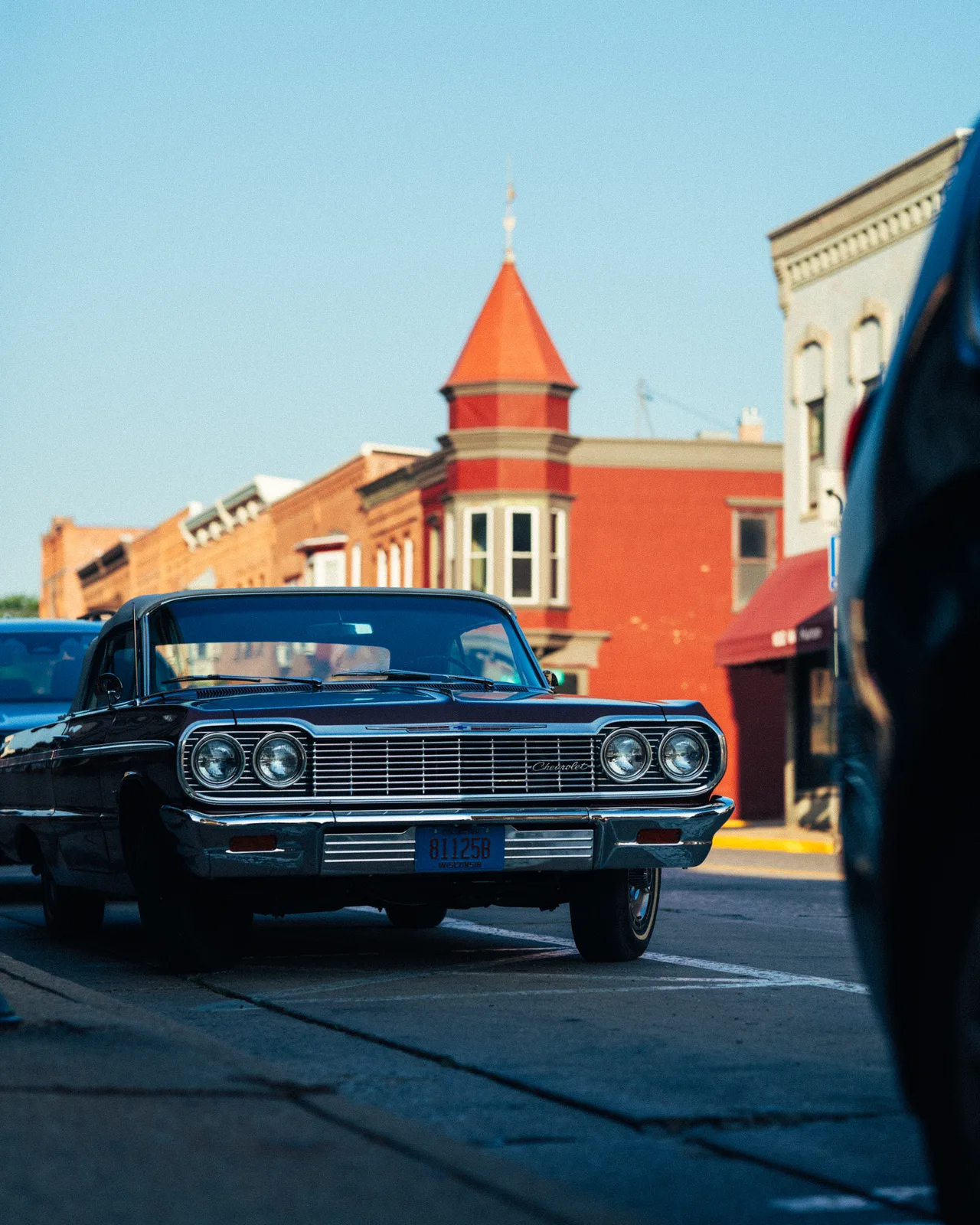 A classic black Chevrolet parked on a downtown Berlin street