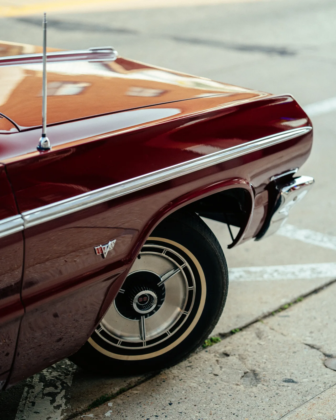 The rear quarter panel and wheel of a burgundy Chevrolet SS