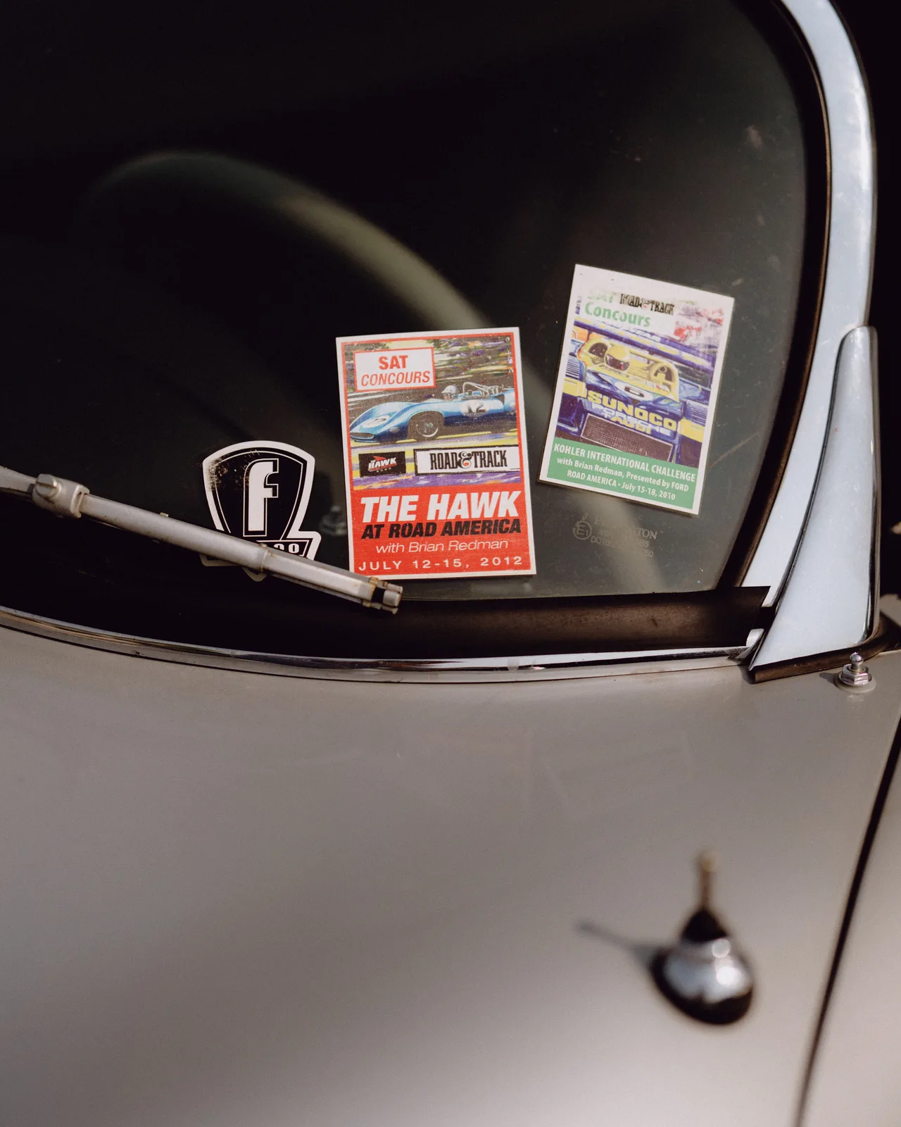 Rally stickers and a Pininfarina badge on the windshield of Curt Cromwell’s Porsche Speedster
