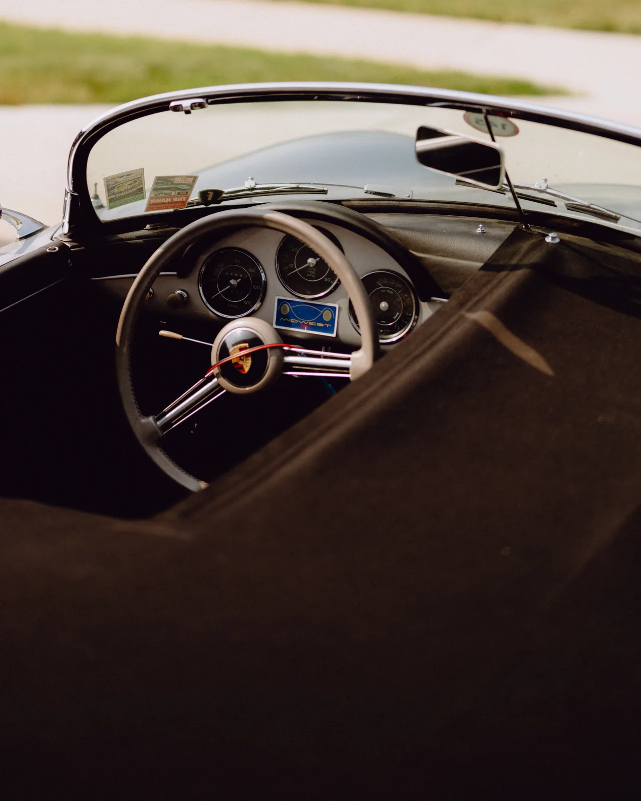 Steering wheel and simple black cockpit of Curt Cromwell’s 1956 Porsche Speedster