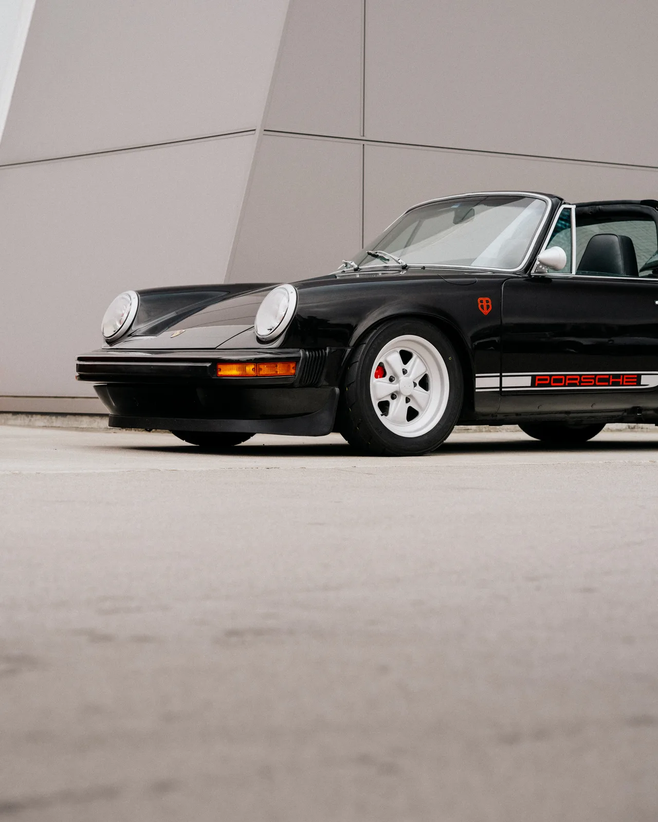 A black classic Porsche 911 parked at Cars and Coffee in Zionsville
