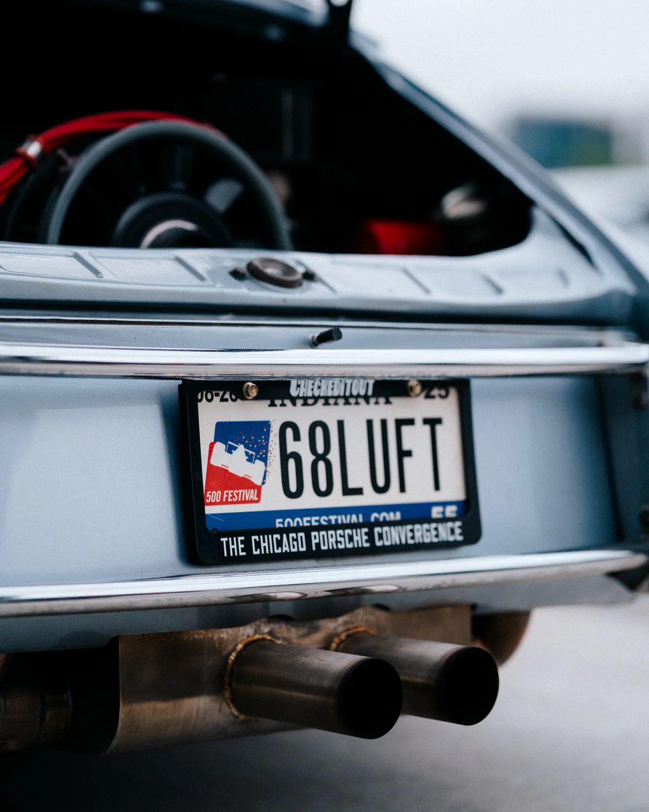 Indiana 68LOFT plate and twin exhaust tips on a silver Porsche