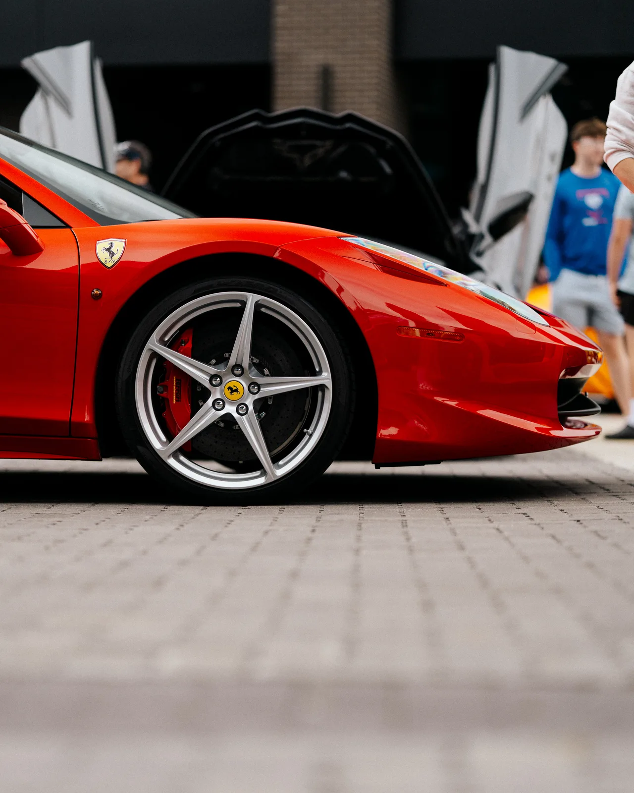 The front wheel and fender of a red Ferrari at Graham Rahal Performance