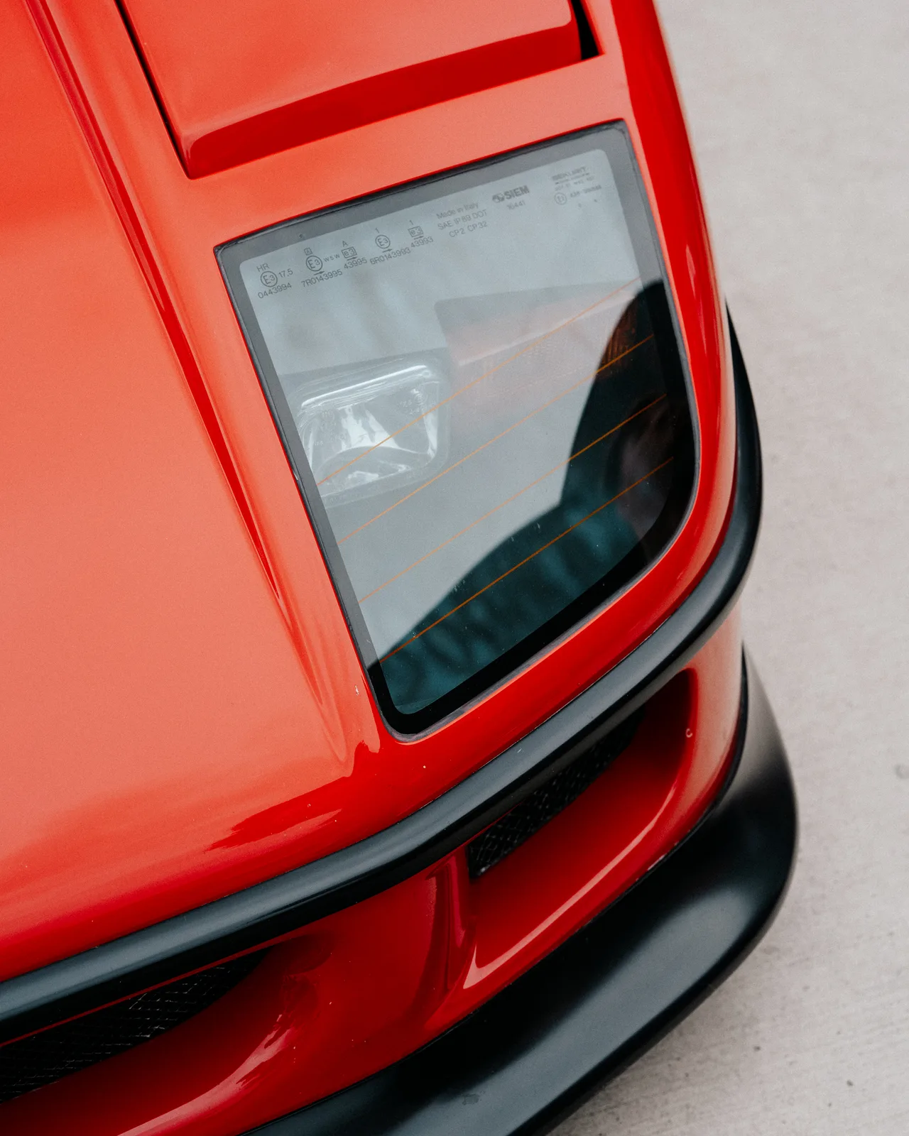 The pop-up headlamp and nose of a red Ferrari